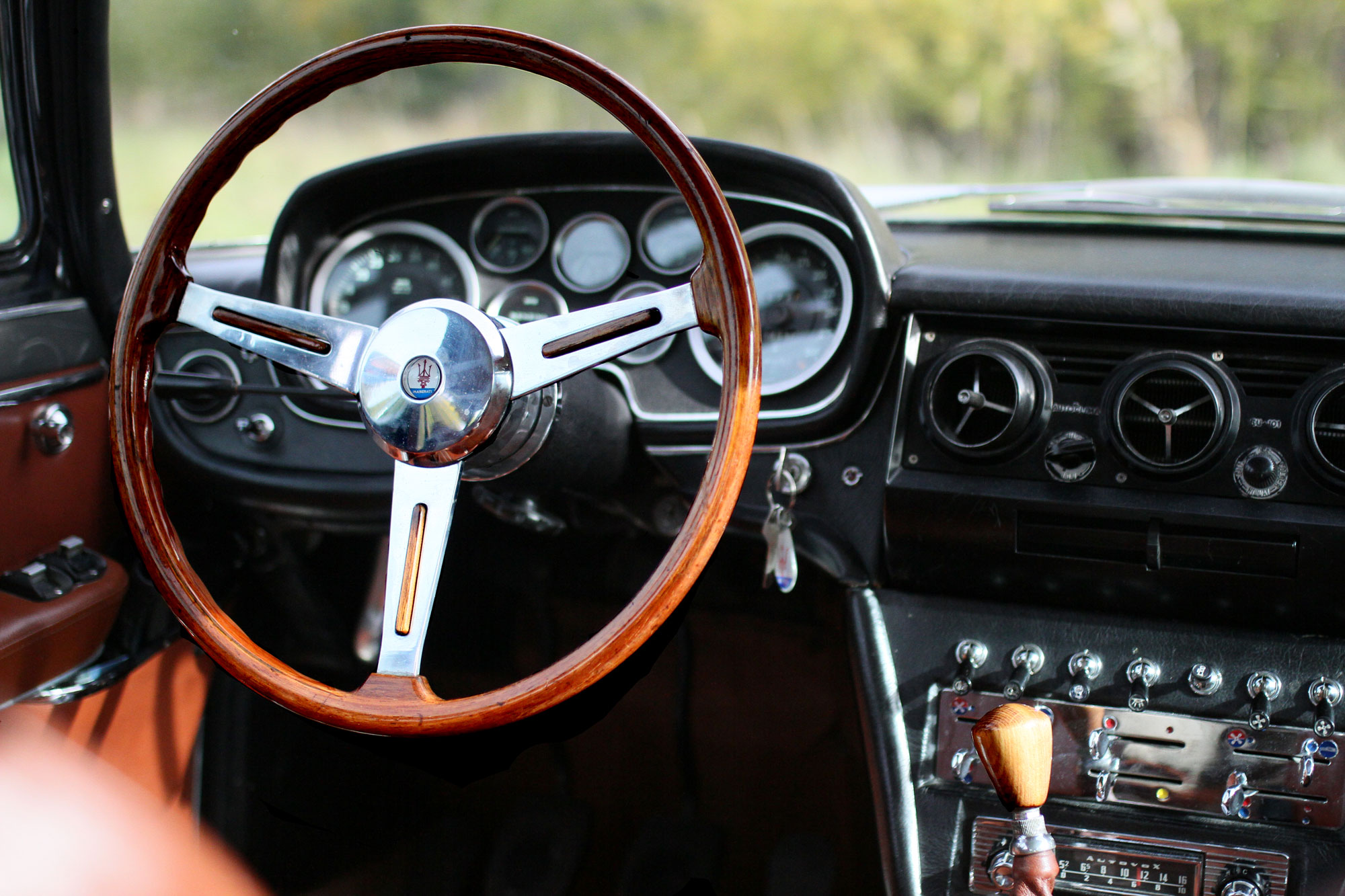 Inviting driver's seat with beautiful woods and inviting furnishings in a classic Maserati Quattroporte